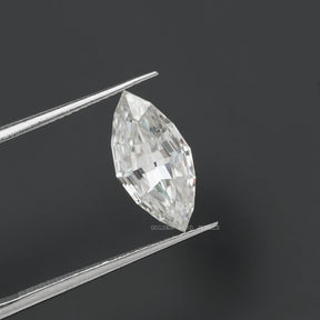 in tweezer side view of colorless step cut marquise moissanite stone