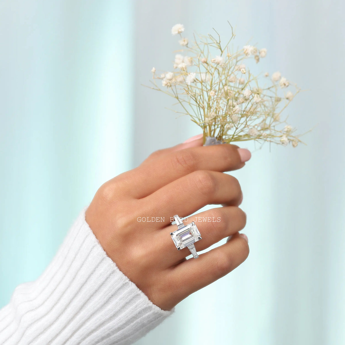 View of Emerald Cut Three Stone Moissanite Ring In Finger
